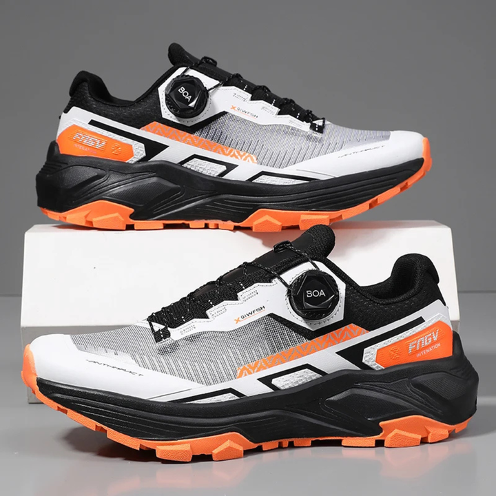 Pair of orange running shoes on a gray background