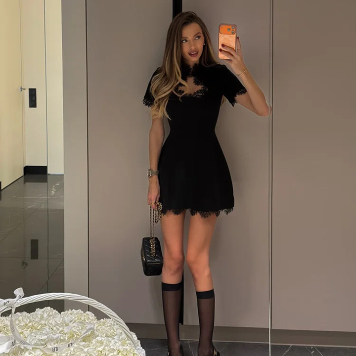 Woman wearing a Atelier Noir Patchwork Mini Dress in indoor setting.