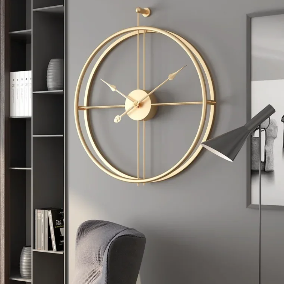 Gold Aurelle Modern Wall Clock on a gray wall with a modern interior setting.