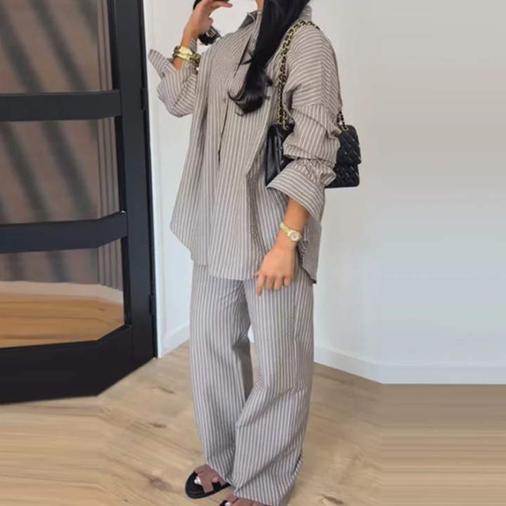 Person wearing a Gray Celeste Minimal Power Set standing in a room with wooden flooring.