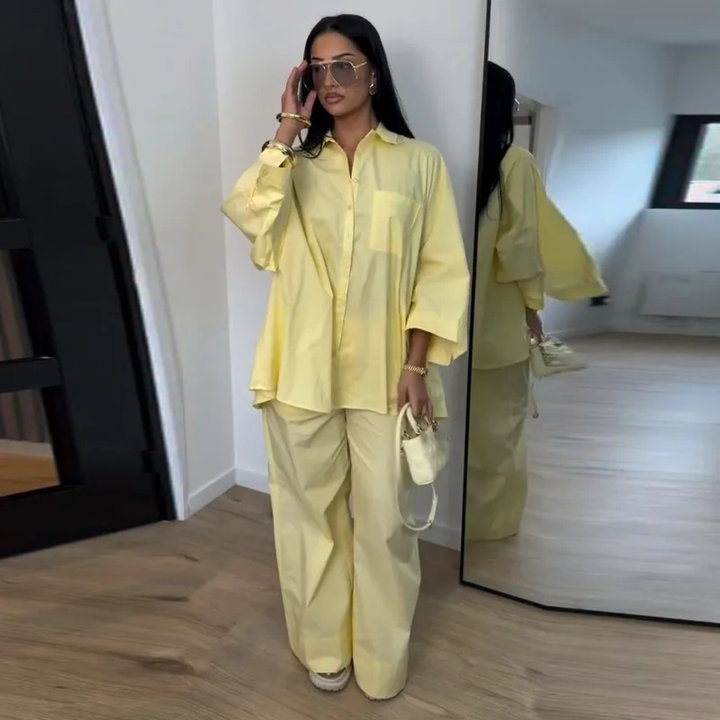 Woman in a Yellow Celeste Minimal Power Set outfit standing in front of a mirror.