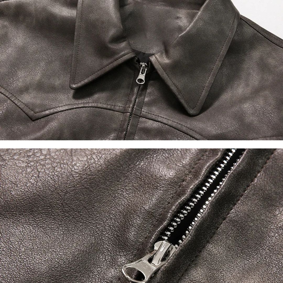 Close-up of a dark brown leather jacket with a zipper