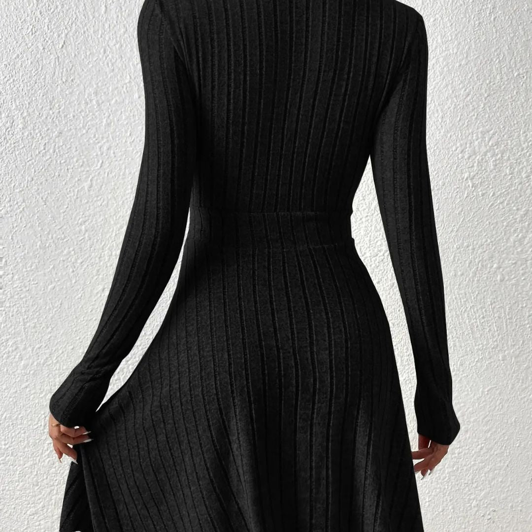 Black ribbed dress with long sleeves on a white background