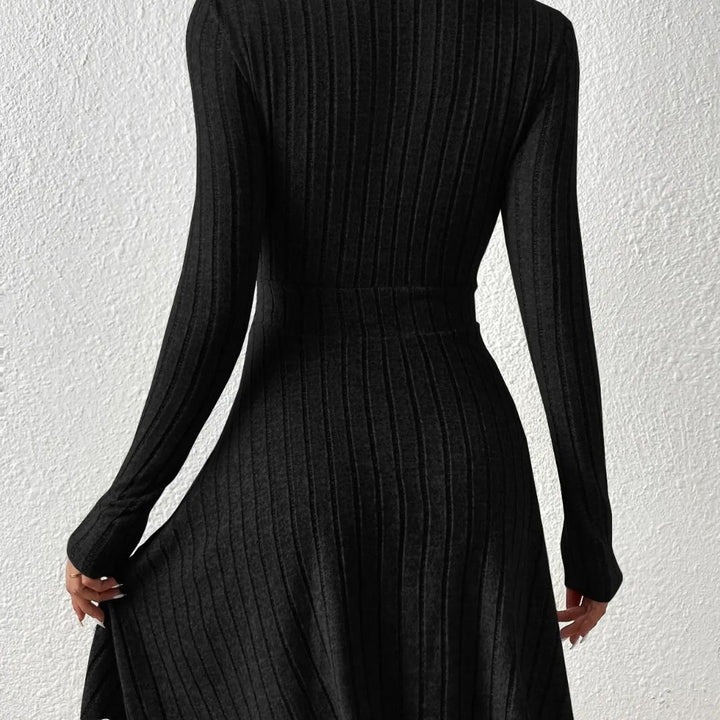 Black ribbed dress with long sleeves on a white background
