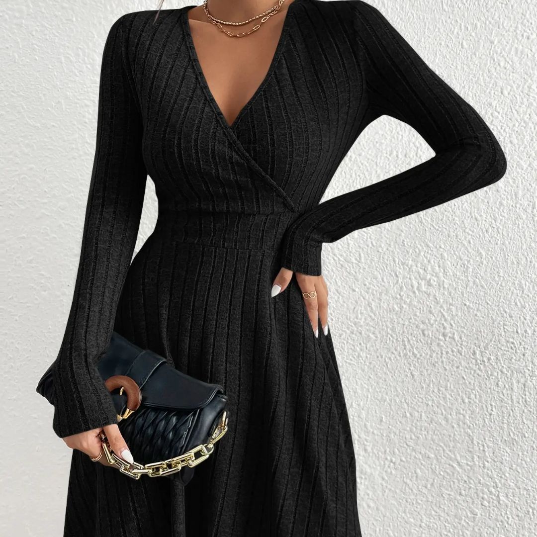 Black ribbed dress worn by a person against a white background
