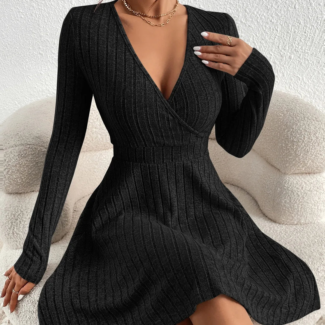 Black ribbed dress worn by a person on a neutral background