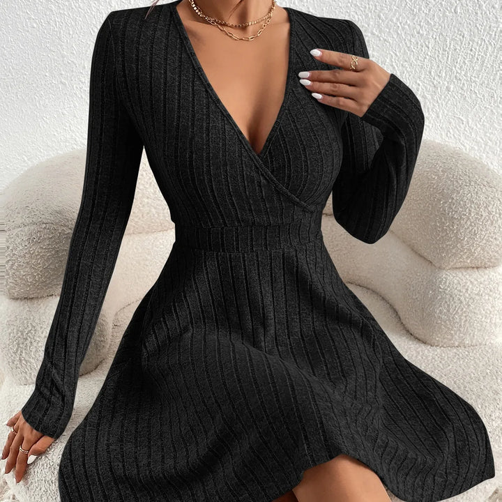 Black ribbed dress worn by a person on a neutral background