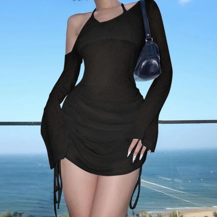 Person wearing a black Evangeline Lace-Up Bodycon Dress, standing against a scenic background.