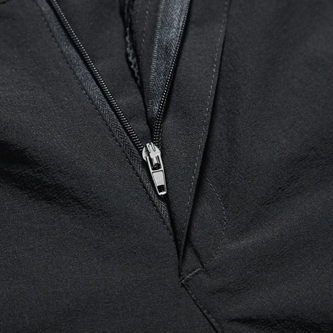 Close-up of a black pants zipper with a silver zipper pull.