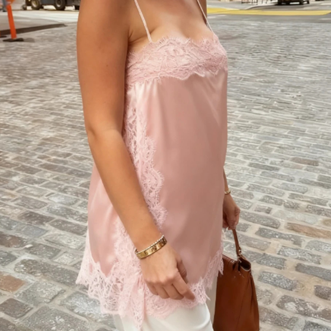 Person wearing Pink Isolde Satin Lace Top in outdoor setting.