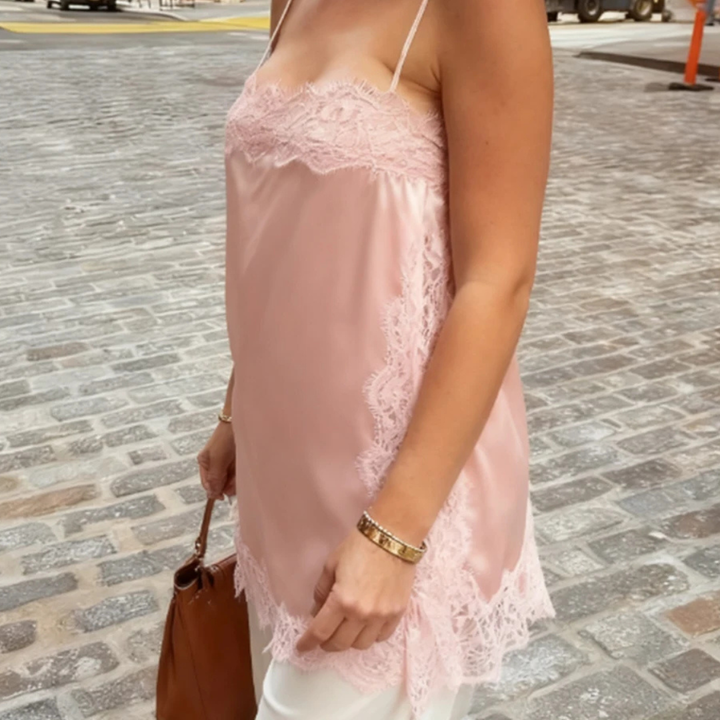 Person wearing Pink Isolde Satin Lace Top in outdoor setting.