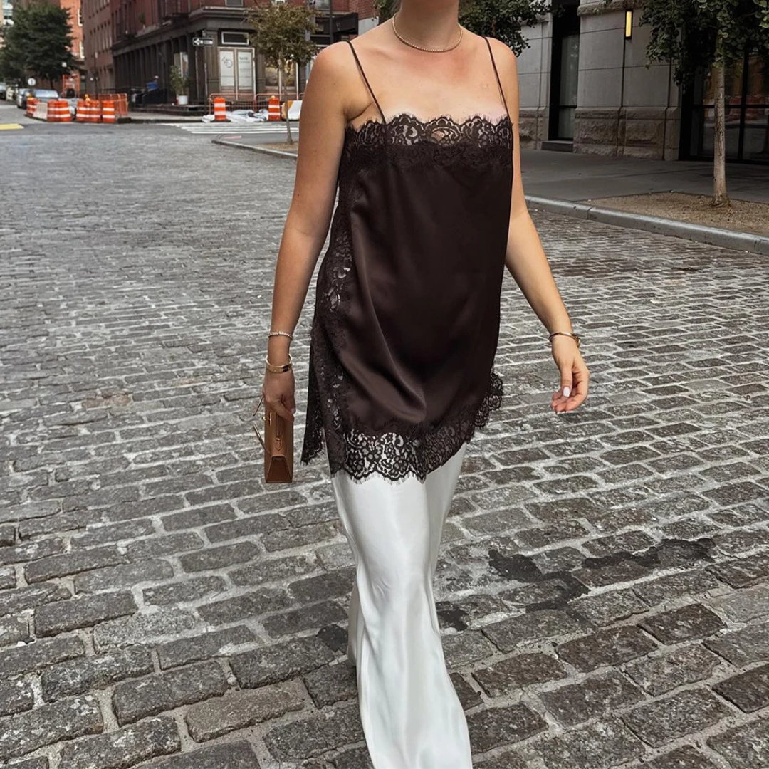 Person wearing Brown Isolde Satin Lace Top in outdoor setting.