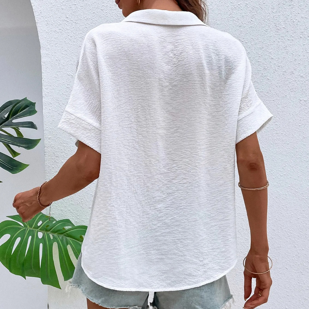Person wearing a white Liliana Silk Drift Chiffon Blouse against a light background
