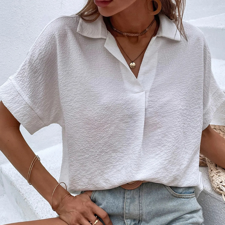 Person wearing a white Liliana Silk Drift Chiffon Blouse against a light background