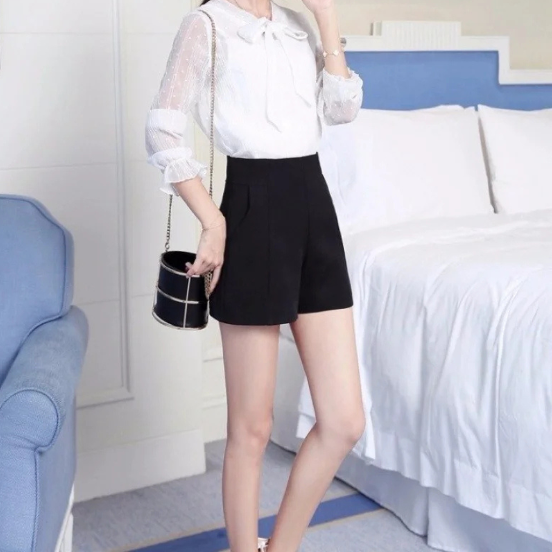 Black Lunae Chic Flow Shorts in a bedroom setting