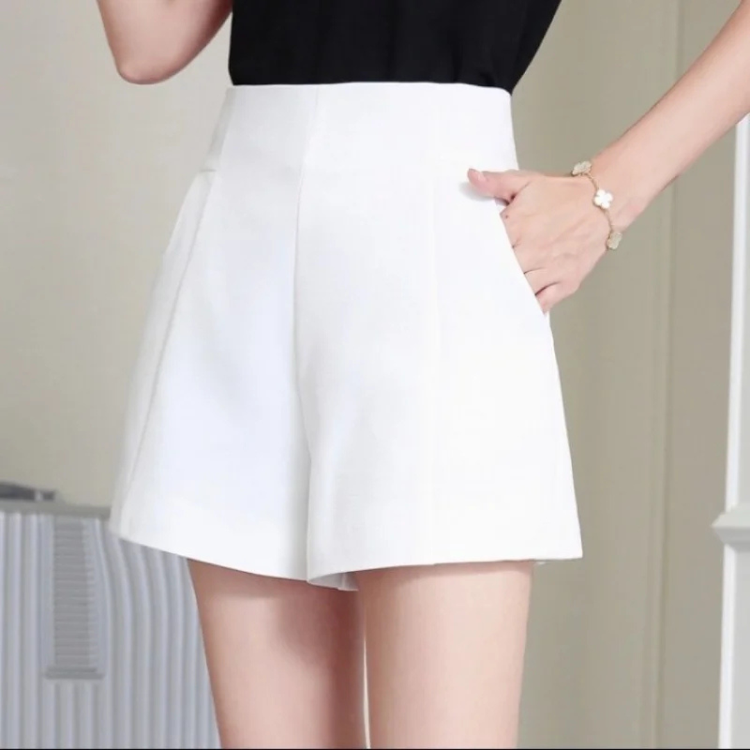 White Lunae Chic Flow Shorts worn by a person against a neutral background
