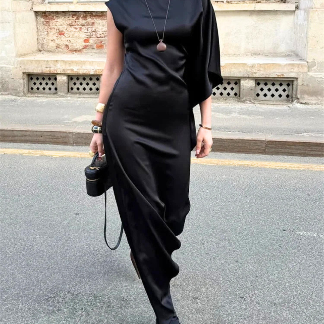 Person wearing a black dress with a blurred background