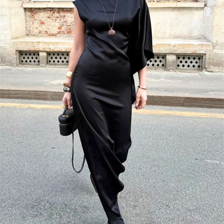 Person wearing a black dress with a blurred background