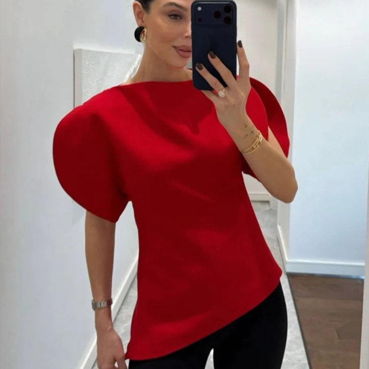 Person wearing a red top taking a mirror selfie.