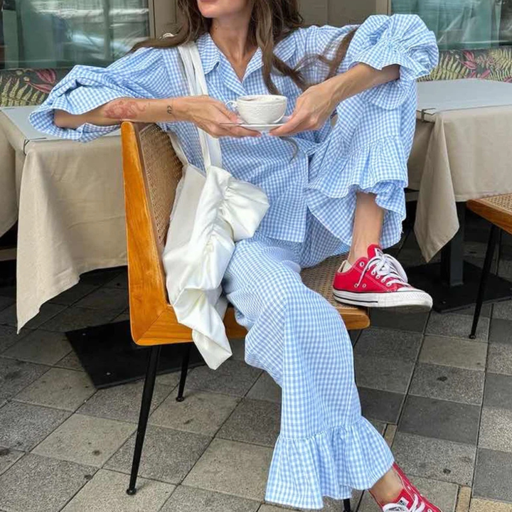 Person wearing a Blue Nova Sharp 2-Piece Set checkered outfit with ruffled pants in an outdoor setting.