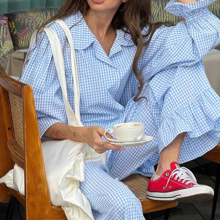 Person wearing a Blue Nova Sharp 2-Piece Set checkered outfit with ruffled pants in an outdoor setting.