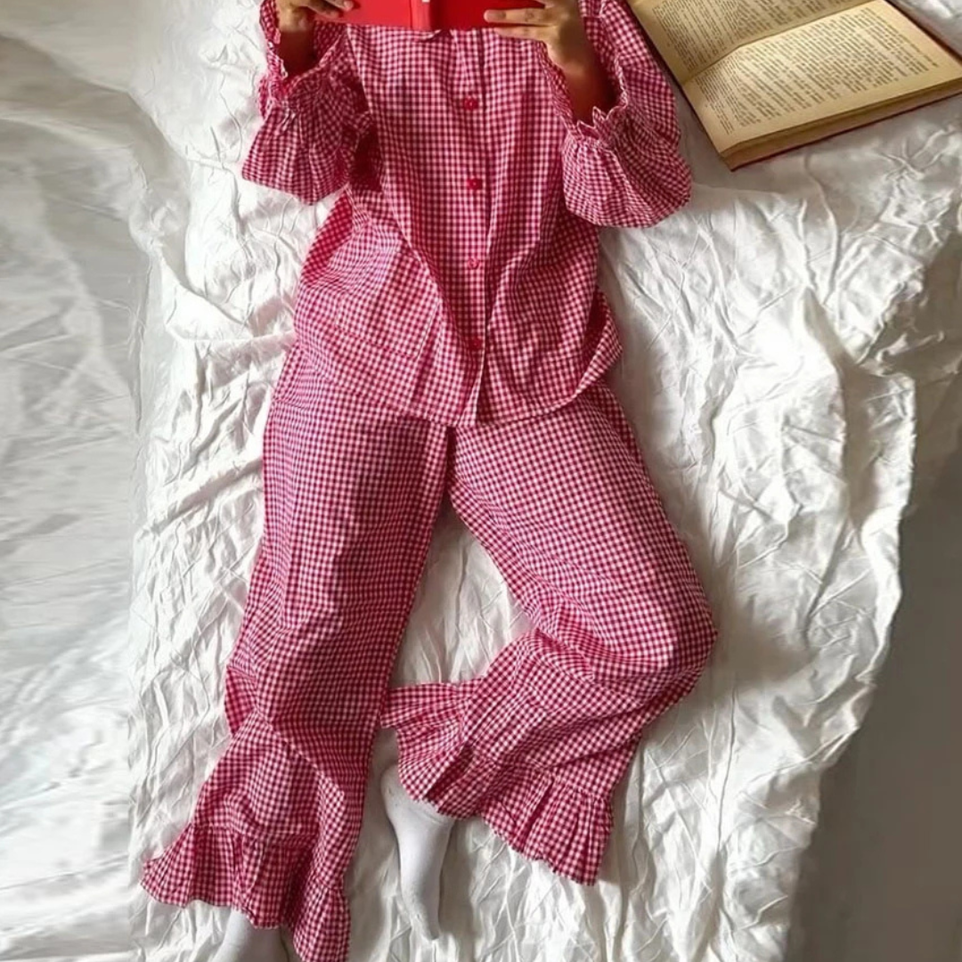 Person wearing Red Nova Sharp 2-Piece Set lying on a white bed with an open book.