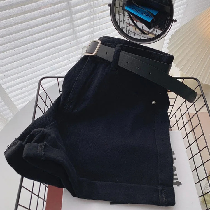 Outlaw Muse Wide-Leg Black Denim Shorts jacket on a hanger with a white background