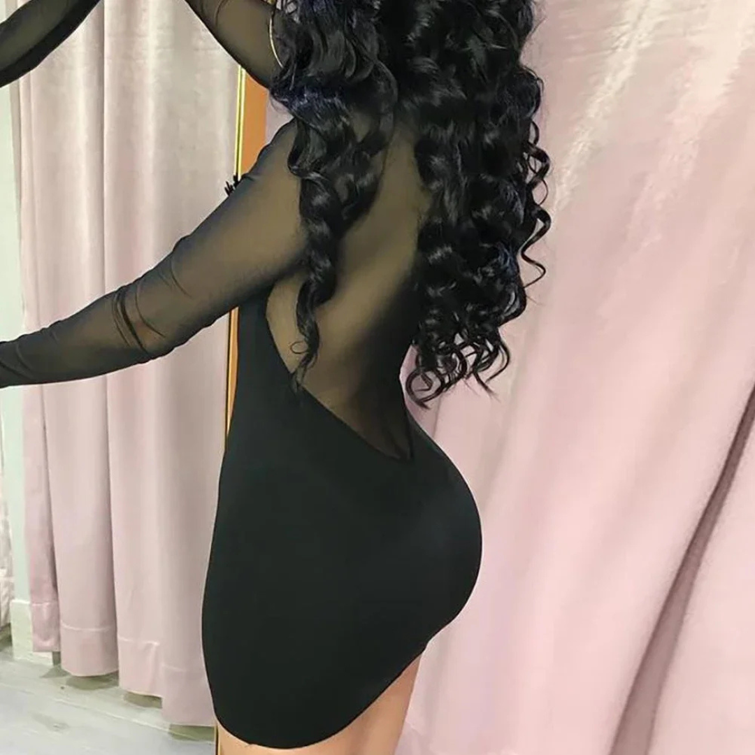 Person wearing a Rosalina Night Edge Mesh Mini Dress with sheer panels in a room.
