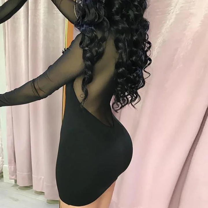 Person wearing a Rosalina Night Edge Mesh Mini Dress with sheer panels in a room.