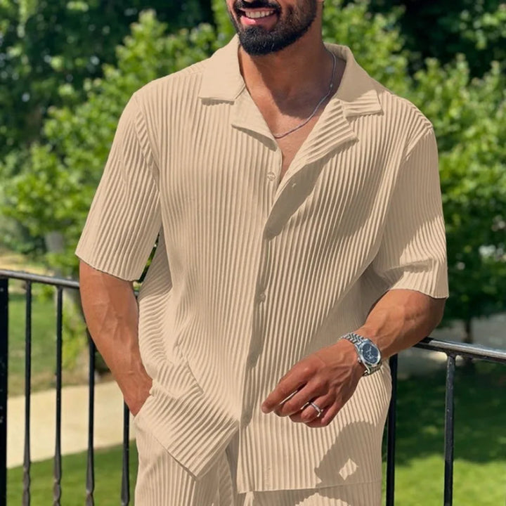 Man wearing a apricot short-sleeve shirt with a collar and pants in outdoors.