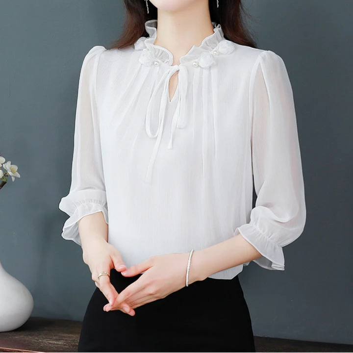 Woman wearing a white blouse with a gray background