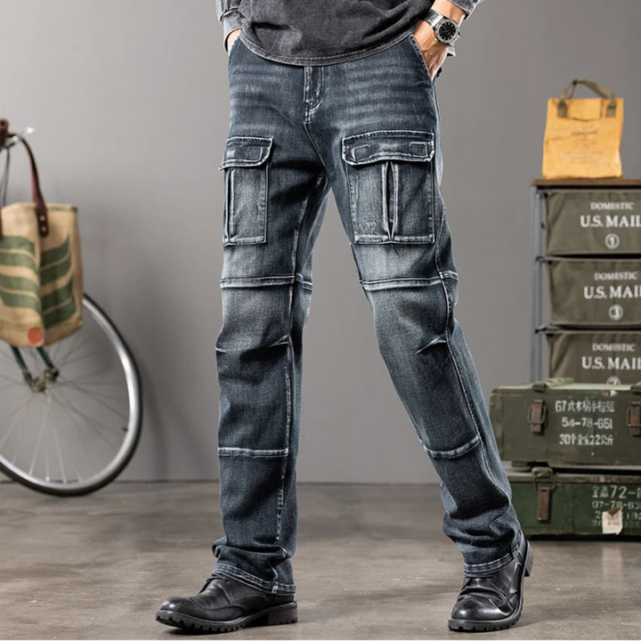 Person wearing rugged blue jeans with cargo pockets in a casual setting with bicycles and mail boxes.