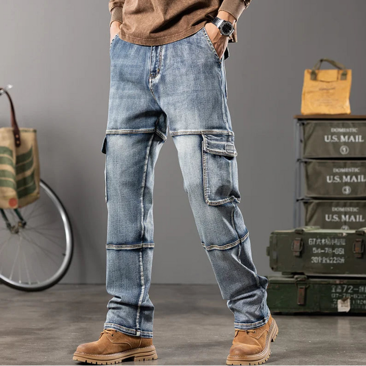 Person wearing blue jeans with cargo pockets in a casual setting with a bicycle and storage boxes.