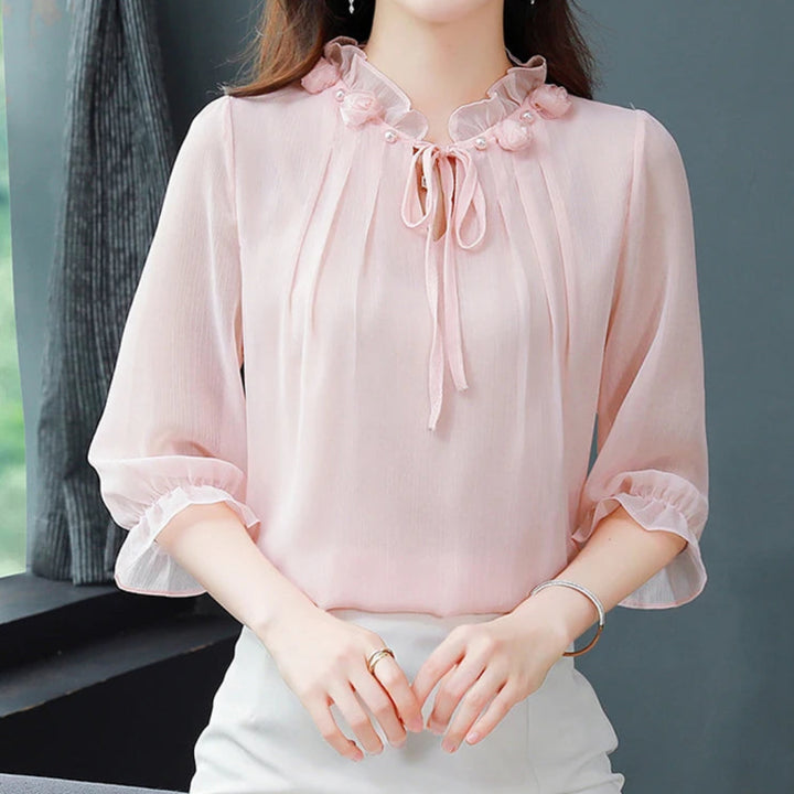 Woman wearing a pink blouse with a blurred background