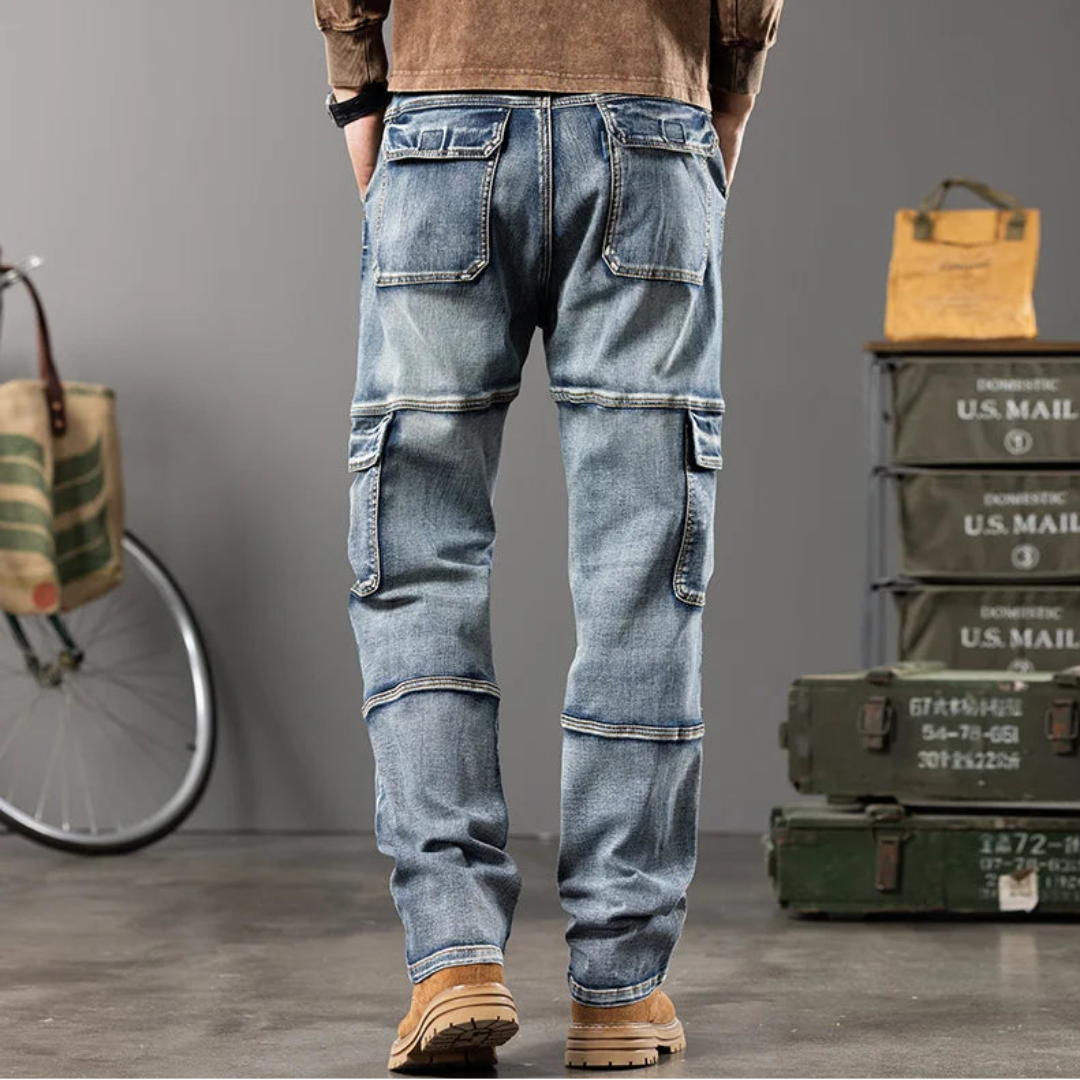 Person wearing blue jeans with cargo pockets in a casual setting with a bicycle and mail crates.