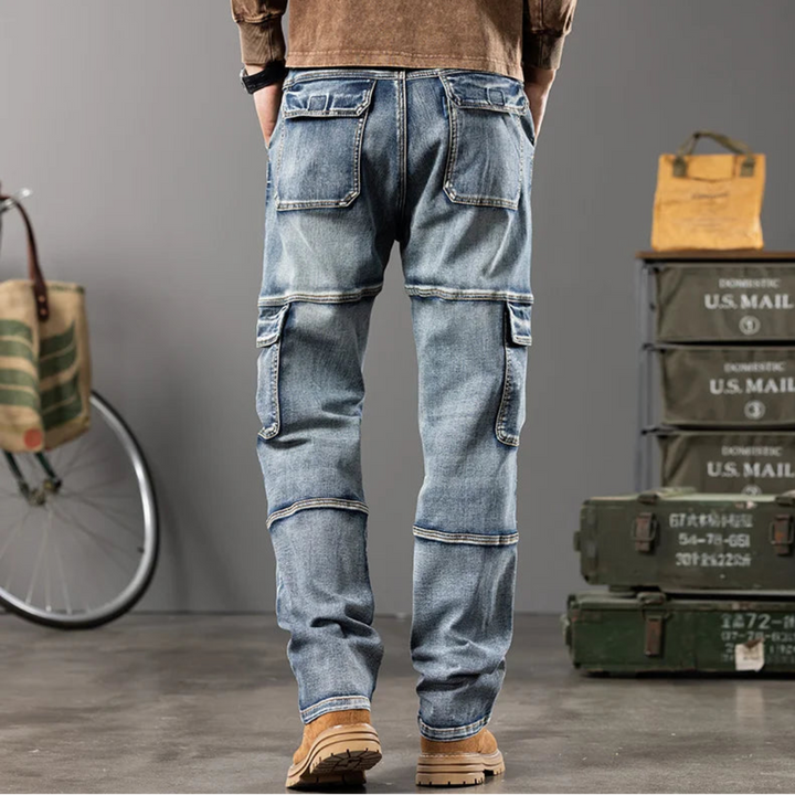Person wearing blue jeans with cargo pockets in a casual setting with a bicycle and mail crates.