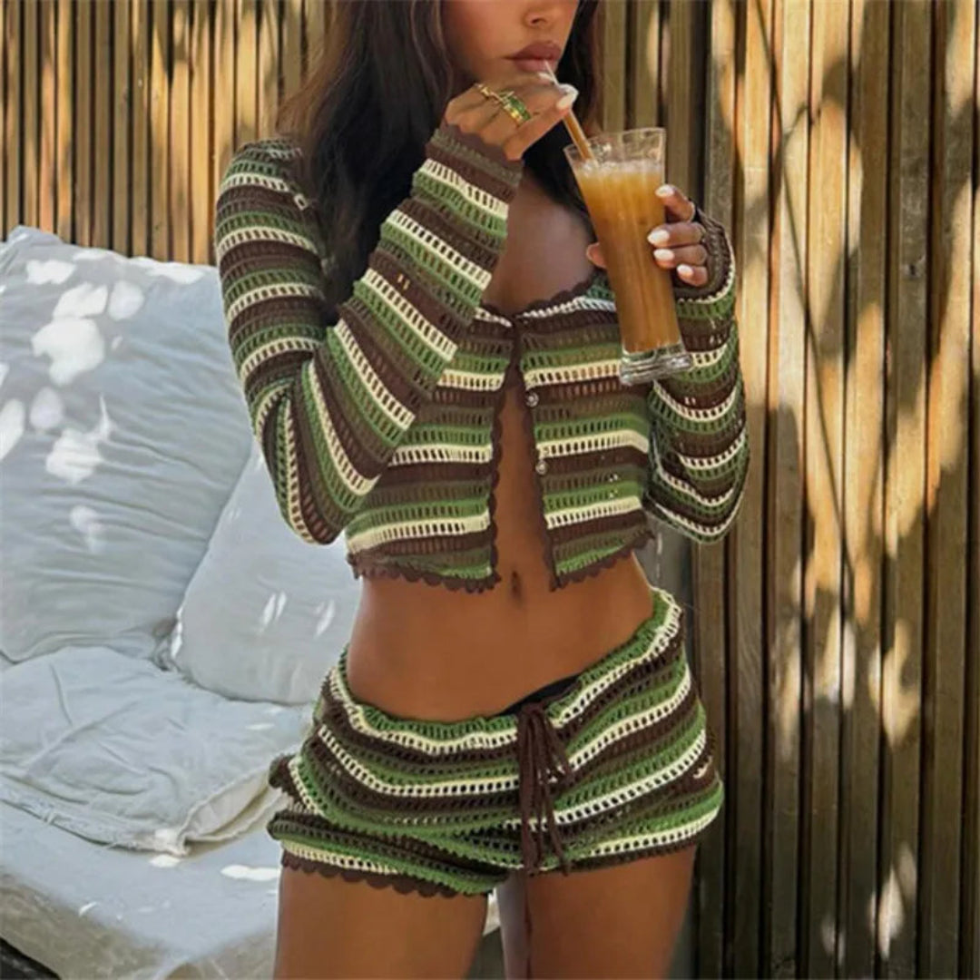 Woman in a green striped outfit drinking from a glass.