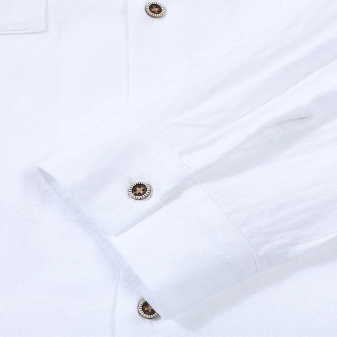 Close-up of a white shirt with buttons on a light gray background