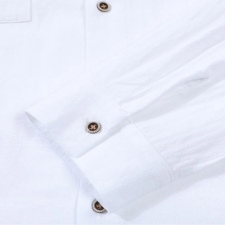 Close-up of a white shirt with buttons on a light gray background