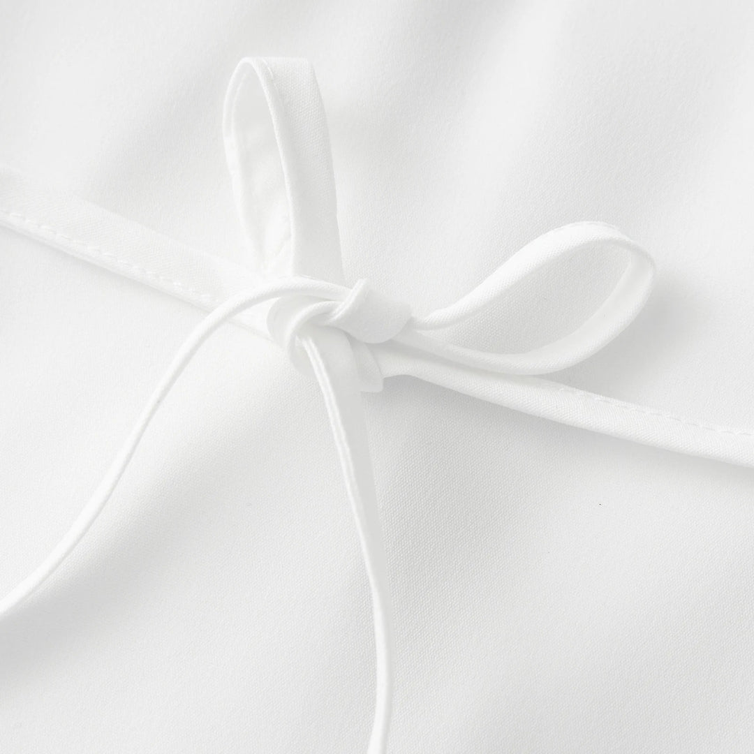 Close-up of a white shirt on a light gray background