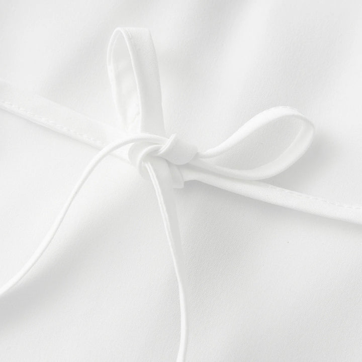 Close-up of a white shirt on a light gray background