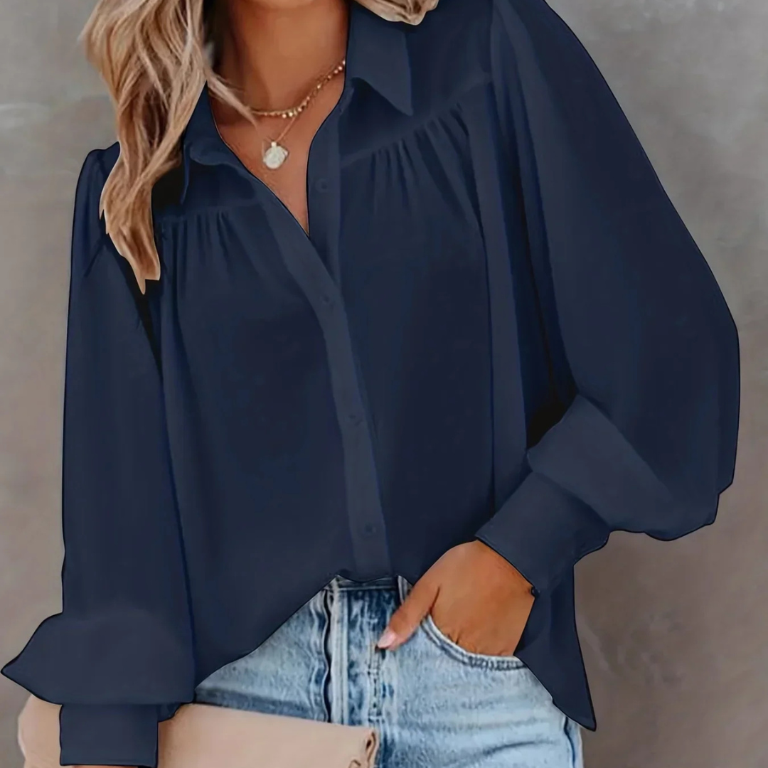 Person wearing a blue Selestina Vogue Edge Plus Size Blouse with a blurred background