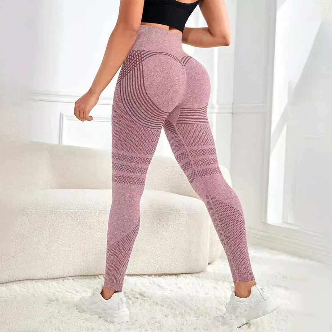 Person wearing pink patterned leggings in a bright room