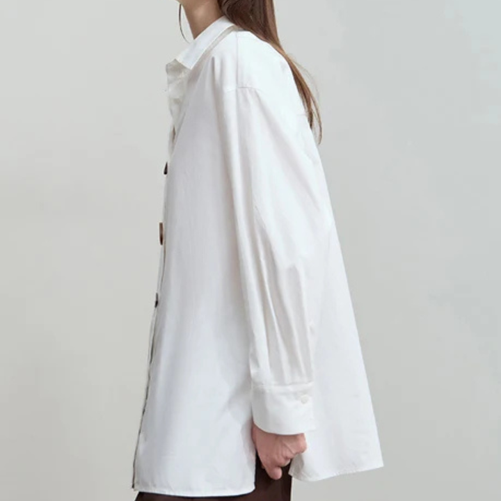 White shirt worn by a person on a plain background