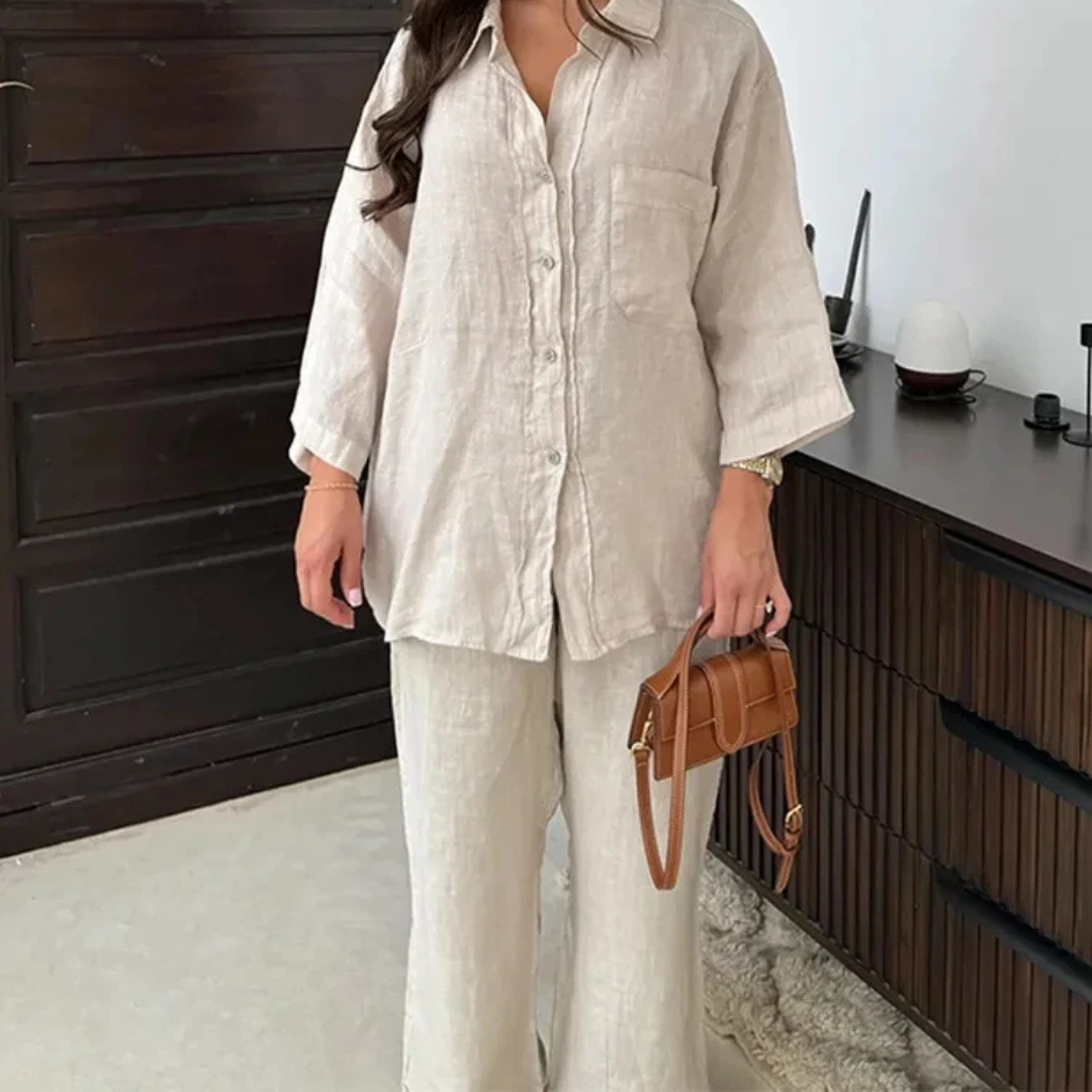 Person wearing a beige Vanta Femme Structured 2-Piece Set outfit holding a brown handbag in an indoor setting.