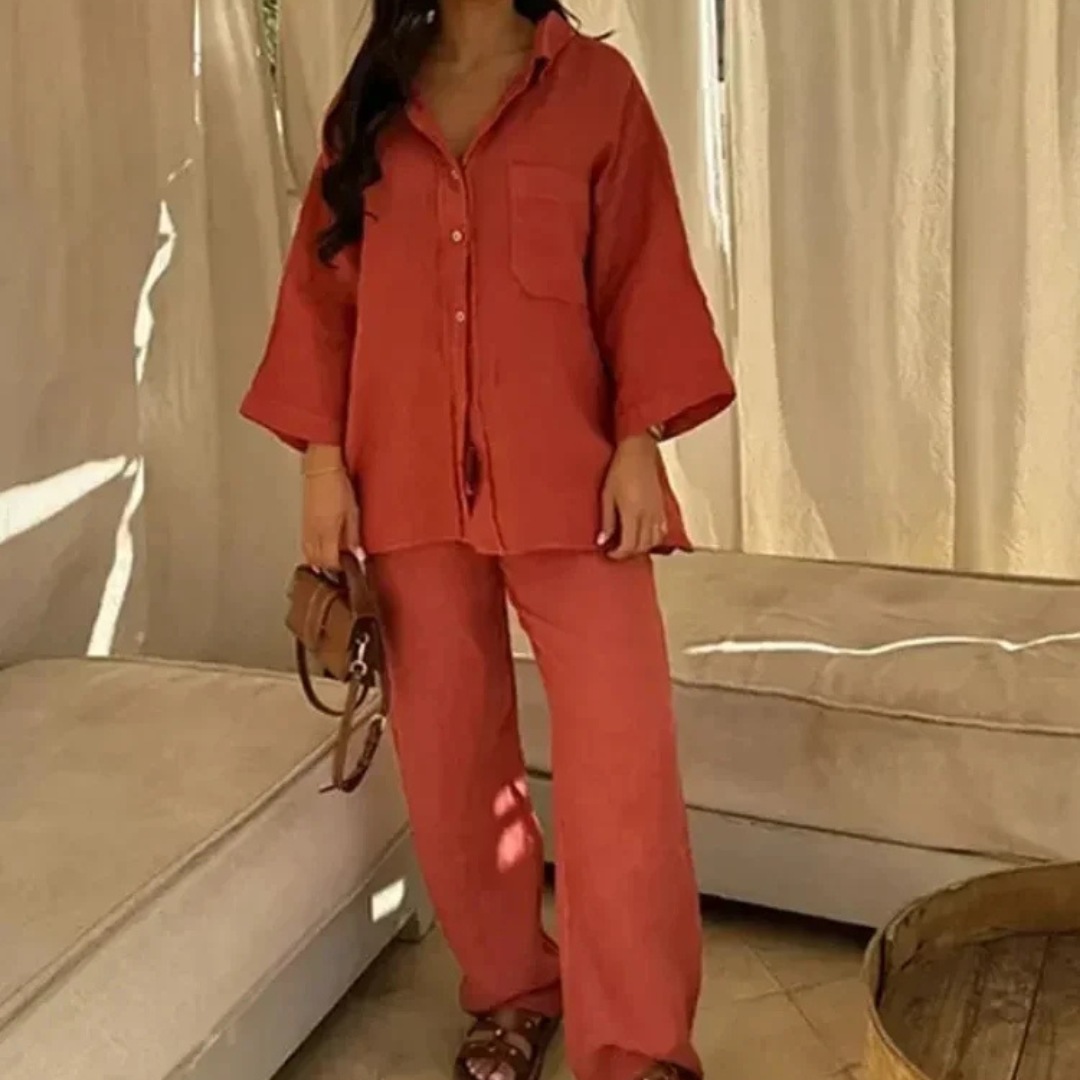 Person wearing a Orange Vanta Femme Structured 2-Piece Set outfit standing in a room with beige curtains and furniture.
