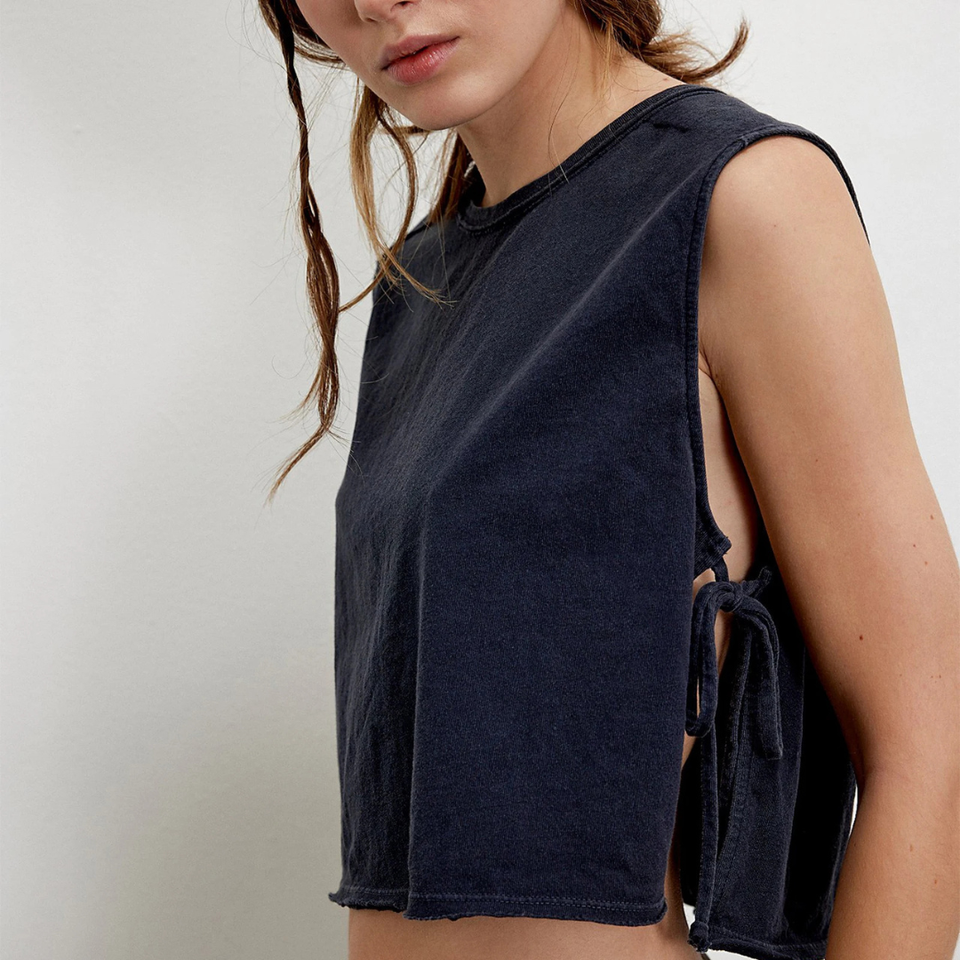 Person wearing a black Vanta Grace Vintage Crop Top with tied sides on a plain background