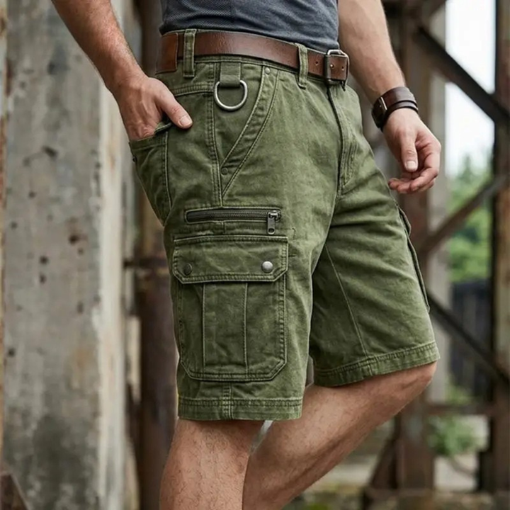 Person wearing green cargo shorts with a blurred background