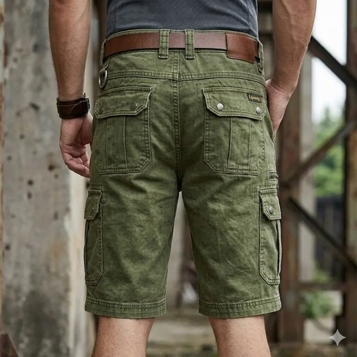 Person wearing green cargo shorts with a blurred background