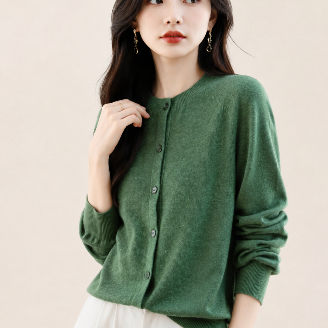 Woman wearing a green cardigan against a beige background